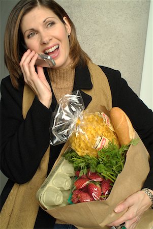 Woman on Cell Phone, Holding Bag of Groceries Stock Photo - Rights-Managed, Code: 700-00164327