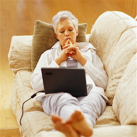 simsearch:700-00053497,k - Woman Relaxing on Sofa with Laptop Computer Stock Photo - Rights-Managed, Code: 700-00164539