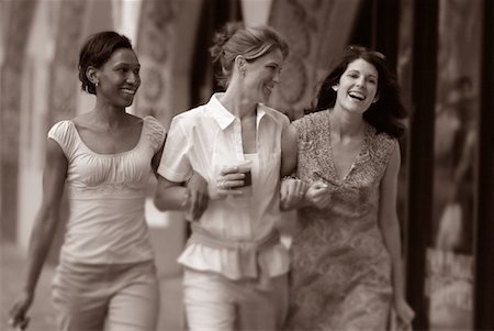 Pictures of three women arm in arm laughing Stock Photos - Page 1