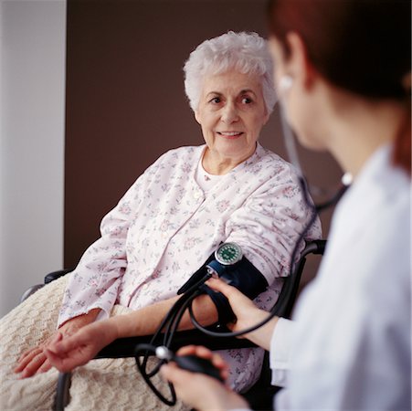 Healthcare Worker Taking Woman's Blood Pressure Stock Photo - Rights-Managed, Code: 700-00166245