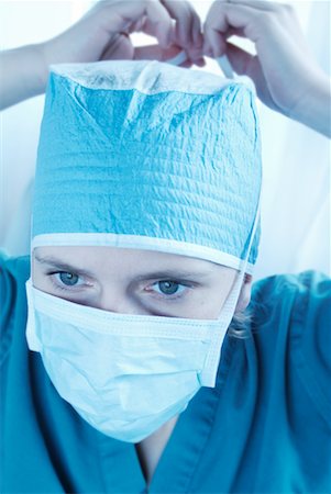 simsearch:700-00560480,k - Woman Putting on Surgical Mask Stock Photo - Rights-Managed, Code: 700-00166560