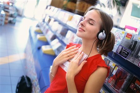 Teenager Listening to Music In Store Stock Photo - Rights-Managed, Code: 700-00167135