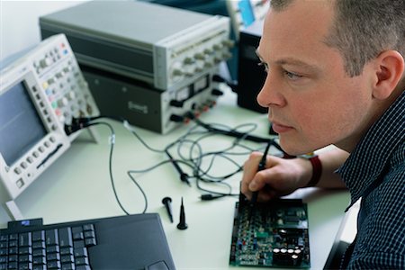 Close-Up of Computer Technician At Work Stock Photo - Rights-Managed, Code: 700-00167685