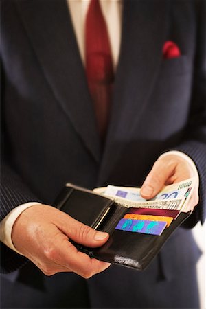 Close-Up of Man Showing Contents Of Wallet Stock Photo - Rights-Managed, Code: 700-00167934