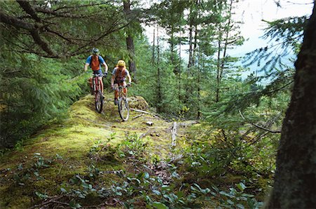 Couple Cycling through Rockies British Columbia, Canada Stock Photo - Rights-Managed, Code: 700-00168582