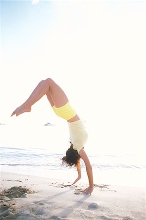 Woman Doing Backflip on Beach Fotografie stock - Rights-Managed, Codice: 700-00160825