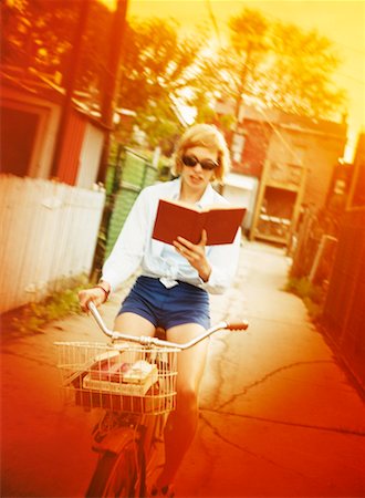 riding bike with basket - Woman Reading and Cycling Stock Photo - Rights-Managed, Code: 700-00162454