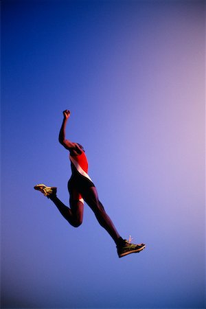 salto in lungo - Athlete Jumping Fotografie stock - Rights-Managed, Codice: 700-00163707