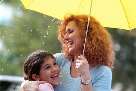 Mother and Daughter with Umbrella in the Rain Stock Photo - Rights-Managed, Code: 700-00177533