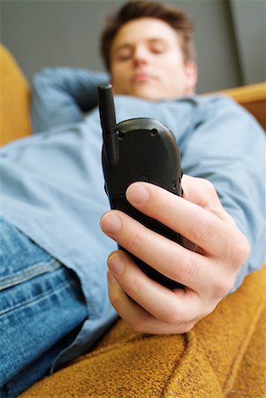 simsearch:700-00557228,k - Man Lying Down Holding Cell Phone Foto de stock - Direito Controlado, Número: 700-00178030