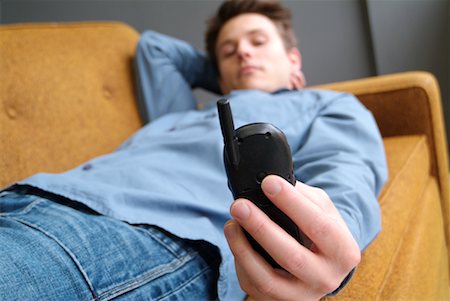 simsearch:700-00782647,k - Man Lying Down Holding Cell Phone Stock Photo - Rights-Managed, Code: 700-00178031