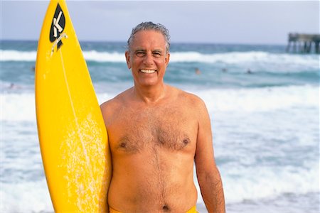 simsearch:700-00547097,k - Homme avec planche de surf Photographie de stock - Rights-Managed, Code: 700-00178438