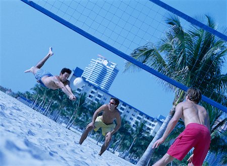 simsearch:400-04406429,k - Men Playing Volleyball on Beach Stock Photo - Rights-Managed, Code: 700-00178994