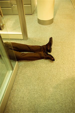 Homme couché sur le plancher Photographie de stock - Rights-Managed, Code: 700-00179253