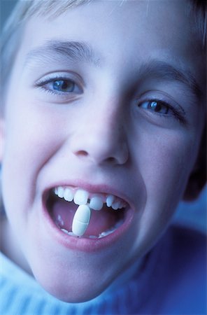 Portrait of Boy with Pill in Mouth Stock Photo - Rights-Managed, Code: 700-00179288
