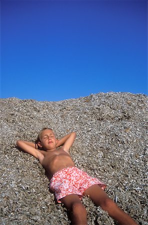 Boy Sleeping on Beach Stock Photo - Rights-Managed, Code: 700-00179282