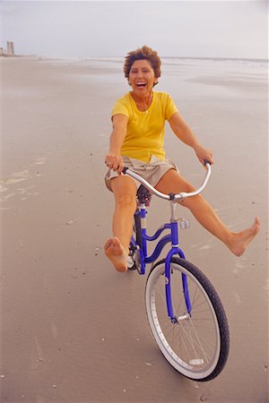 Woman Riding Bike on Beach Stock Photo - Rights-Managed, Code: 700-00170110