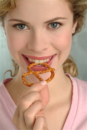 photo of people eating pretzels - Woman Eating Pretzel Stock Photo - Rights-Managed, Code: 700-00184516