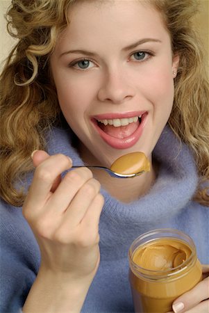 peanut butter woman - Portrait of Woman Eating Peanut Butter Stock Photo - Rights-Managed, Code: 700-00184518
