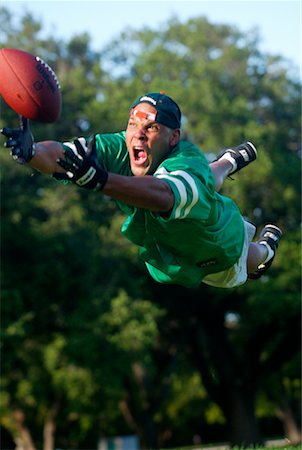 simsearch:700-00328588,k - Man Diving for Football Stock Photo - Rights-Managed, Code: 700-00185329