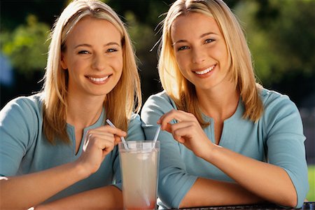 Twin Sisters Sharing a Drink Stock Photo - Rights-Managed, Code: 700-00185579