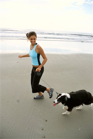 Woman Walking Dog on Beach Stock Photo - Rights-Managed, Code: 700-00185652