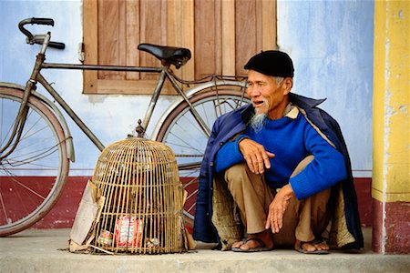 picture of old man on a bike - Man with Birdcage Samson Village, Vietnam Stock Photo - Rights-Managed, Code: 700-00187424