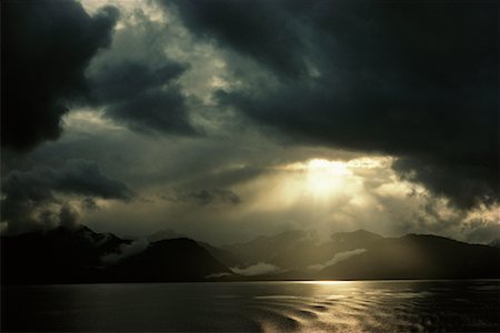 Sun through Storm Clouds over Water Pacific Northwest Coast Stock Photo - Rights-Managed, Code: 700-00188225