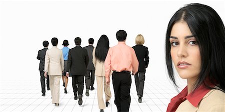 Portrait of Businesswoman with Business People Walking Away Stock Photo - Rights-Managed, Code: 700-00189784