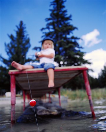 Little girl holding fishing rod Stock Photo by AFGreen