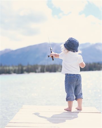 Little Girl Catches Fishing Rod Stock Photo - Image of girl