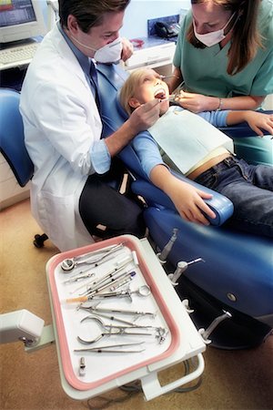 Dentists Working on Girl, Tools in Foreground Stock Photo - Rights-Managed, Code: 700-00194646