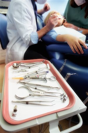 dentistry tray - Dentists Working on Girl, Tools in Foreground Stock Photo - Rights-Managed, Code: 700-00194647