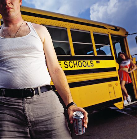 Man and Cheerleader By School Bus Foto de stock - Direito Controlado, Número: 700-00195115