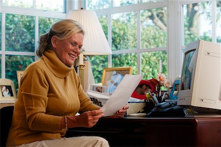 single mature woman 50s home office - Woman Sitting at Desk in Home Office Stock Photo - Rights-Managed, Code: 700-00195215