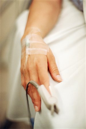 Woman's Hand with Intravenous and Heart Rate Monitor Foto de stock - Direito Controlado, Número: 700-00196346