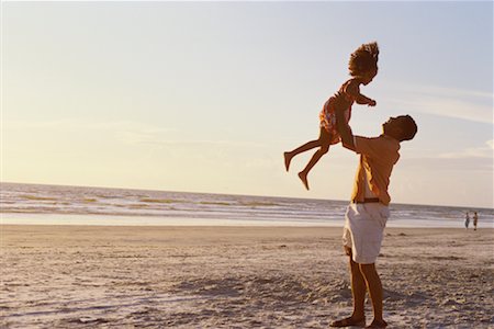 Man Playing with Daughter on Beach Stock Photo - Rights-Managed, Code: 700-00196406