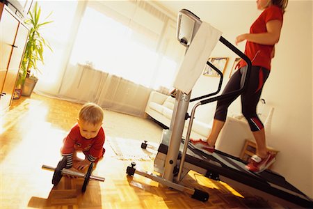 Mother Using Treadmill with Child on Floor Stock Photo - Rights-Managed, Code: 700-00198431