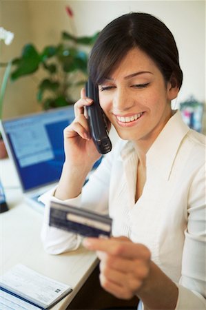 simsearch:700-00269275,k - Femme sur le téléphone avec carte de crédit Photographie de stock - Rights-Managed, Code: 700-00198672