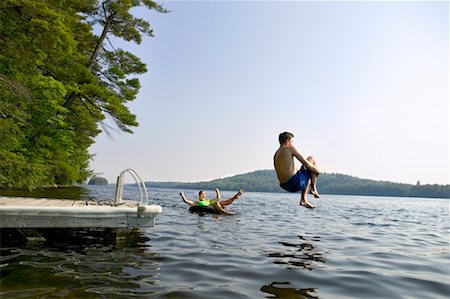 Couple Swimming off Dock Long Pond, Belgrade Lakes Maine, USA Stock Photo - Rights-Managed, Code: 700-00198684