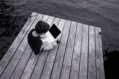 simsearch:700-00520111,k - Boy Sitting on Dock Using Laptop Stock Photo - Rights-Managed, Code: 700-00190214