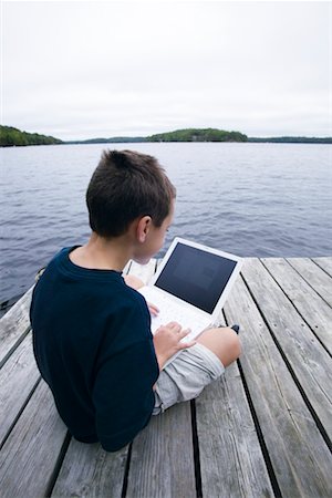 simsearch:700-00520111,k - Boy Sitting on Dock Using Laptop Stock Photo - Rights-Managed, Code: 700-00190213