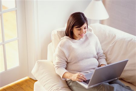 Woman on Sofa Using Laptop Stock Photo - Rights-Managed, Code: 700-00193442