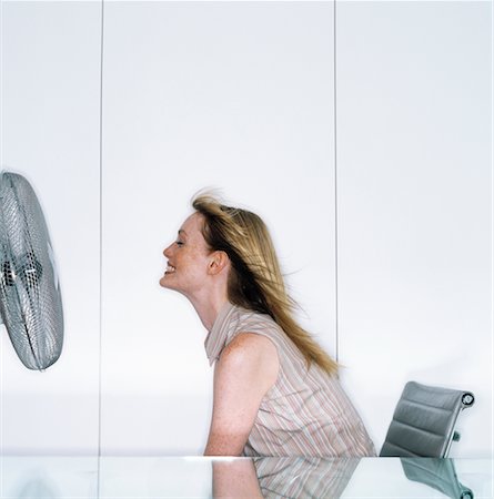 Woman Sitting in Front of Fan Stock Photo - Rights-Managed, Code: 700-00193805