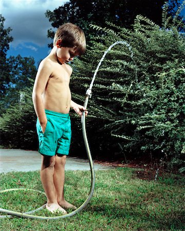 spraying water hose - Boy Holding Garden Hose Stock Photo - Rights-Managed, Code: 700-00193992