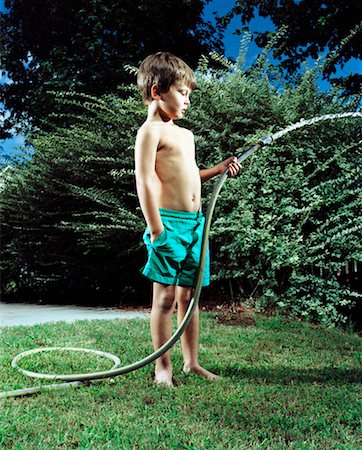 spraying water hose - Boy Holding Garden Hose Stock Photo - Rights-Managed, Code: 700-00193993