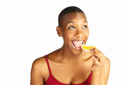 simsearch:700-00403943,k - Woman Eating Orange Slice Foto de stock - Con derechos protegidos, Código: 700-00267726
