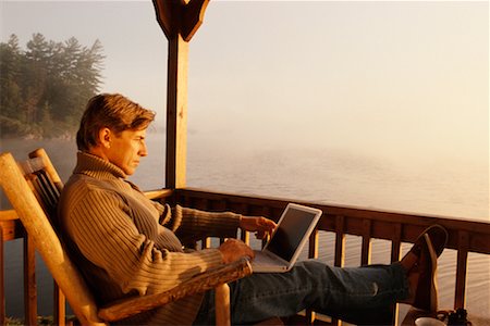 Man at Cottage Using Laptop Stock Photo - Rights-Managed, Code: 700-00267987