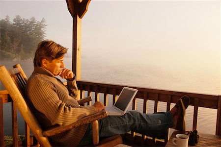 Man at Cottage Using Laptop Stock Photo - Rights-Managed, Code: 700-00267988
