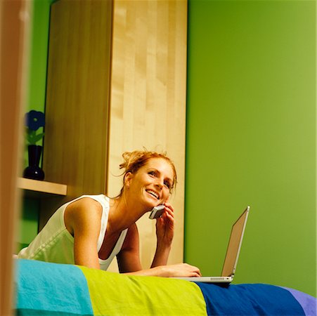 simsearch:700-00782647,k - Woman on Bed with Laptop and Cellular Phone Stock Photo - Rights-Managed, Code: 700-00269050